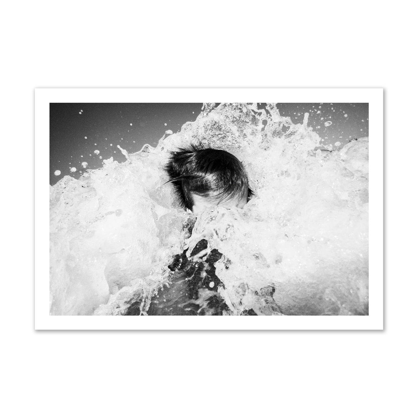 Fine art street photograph of an ocean wave crashing over a swimmer. Archival pigment print, gallery size, print.
