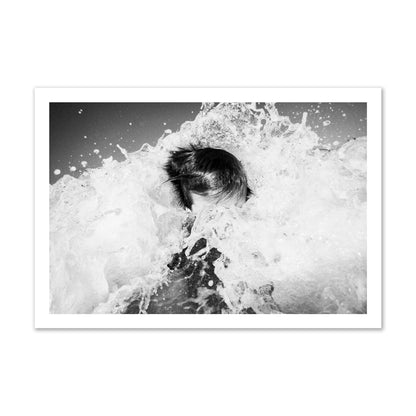 Fine art street photograph of an ocean wave crashing over a swimmer. Archival pigment print, gallery size, print.