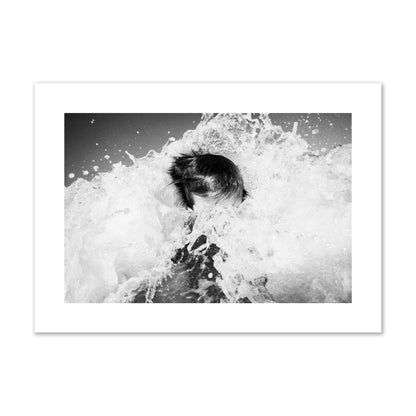 Fine art street photograph of an ocean wave crashing over a swimmer. Archival pigment print, giant size, print.