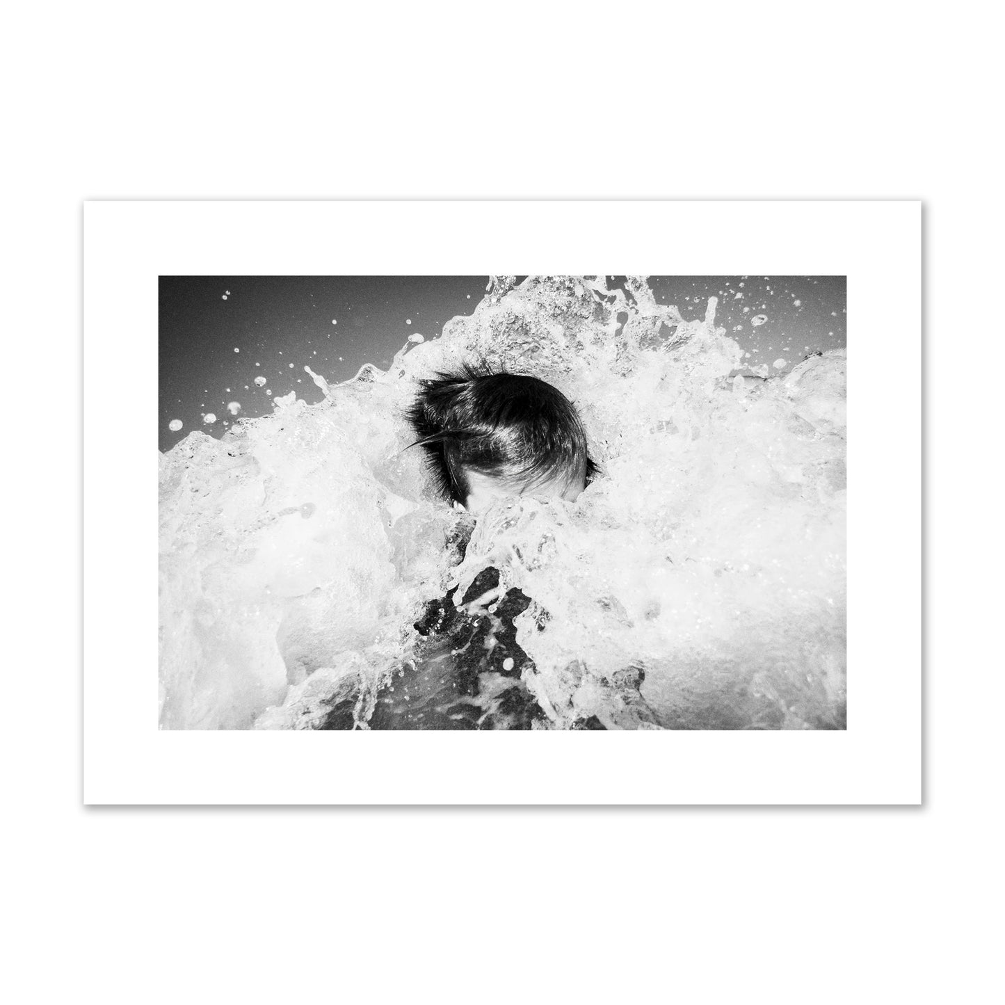 Fine art street photograph of an ocean wave crashing over a swimmer. Archival pigment print, large size, print.