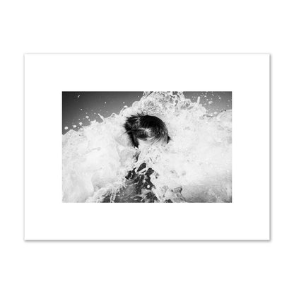 Fine art street photograph of an ocean wave crashing over a swimmer. Archival pigment print, small size, print.