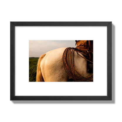 Fine art photo of a cowboy's lasso coiled across a horse's back. Archival pigment print, small size, black frame.
