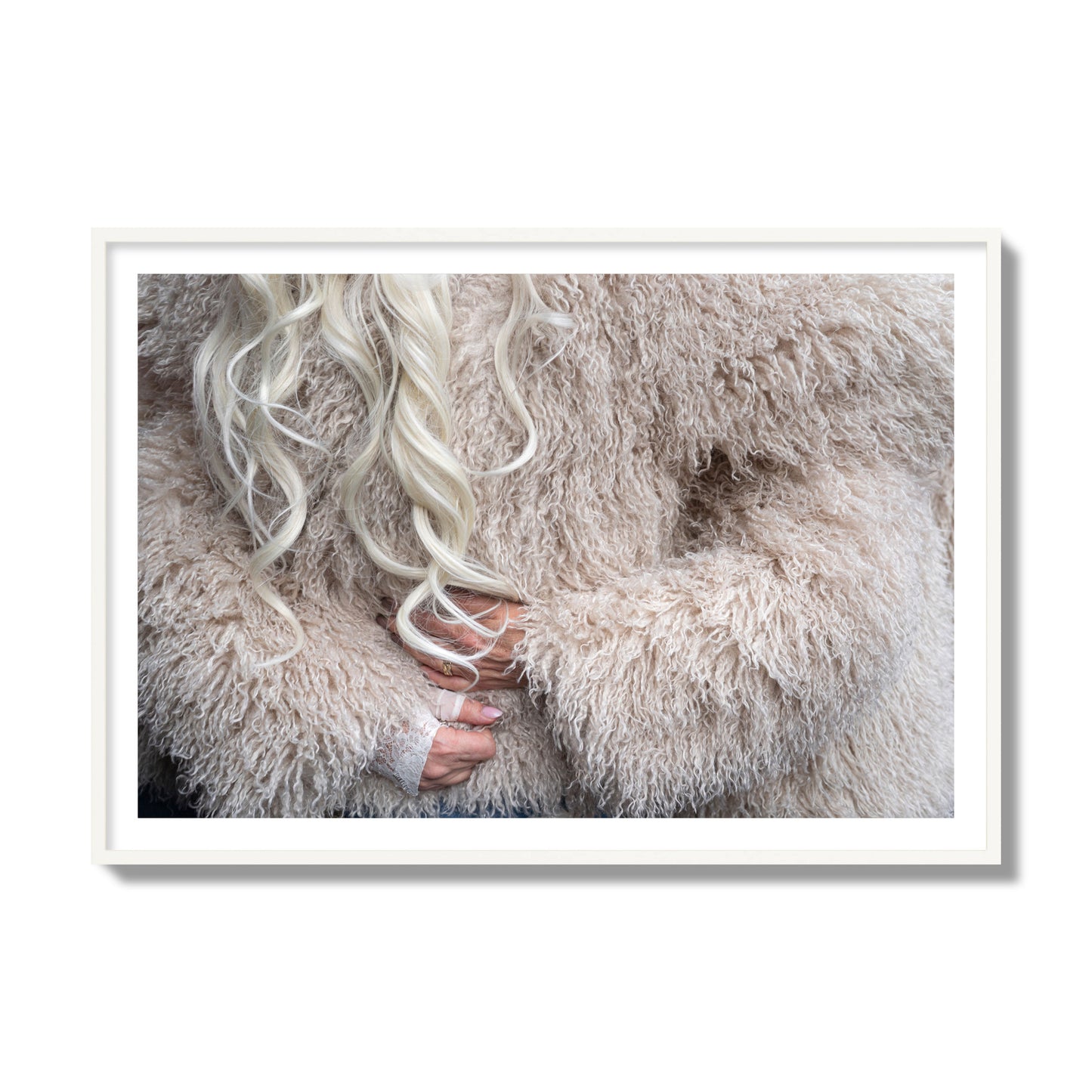 Fine art  street photograph of a woman wrapped in a huge furry coat. Archival pigment print, collector size, white frame.