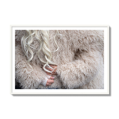 Fine art  street photograph of a woman wrapped in a huge furry coat. Archival pigment print, collector size, white frame.