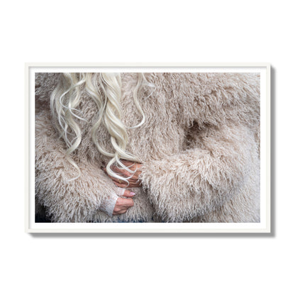 Fine art  street photograph of a woman wrapped in a huge furry coat. Archival pigment print, gallery size, white frame.