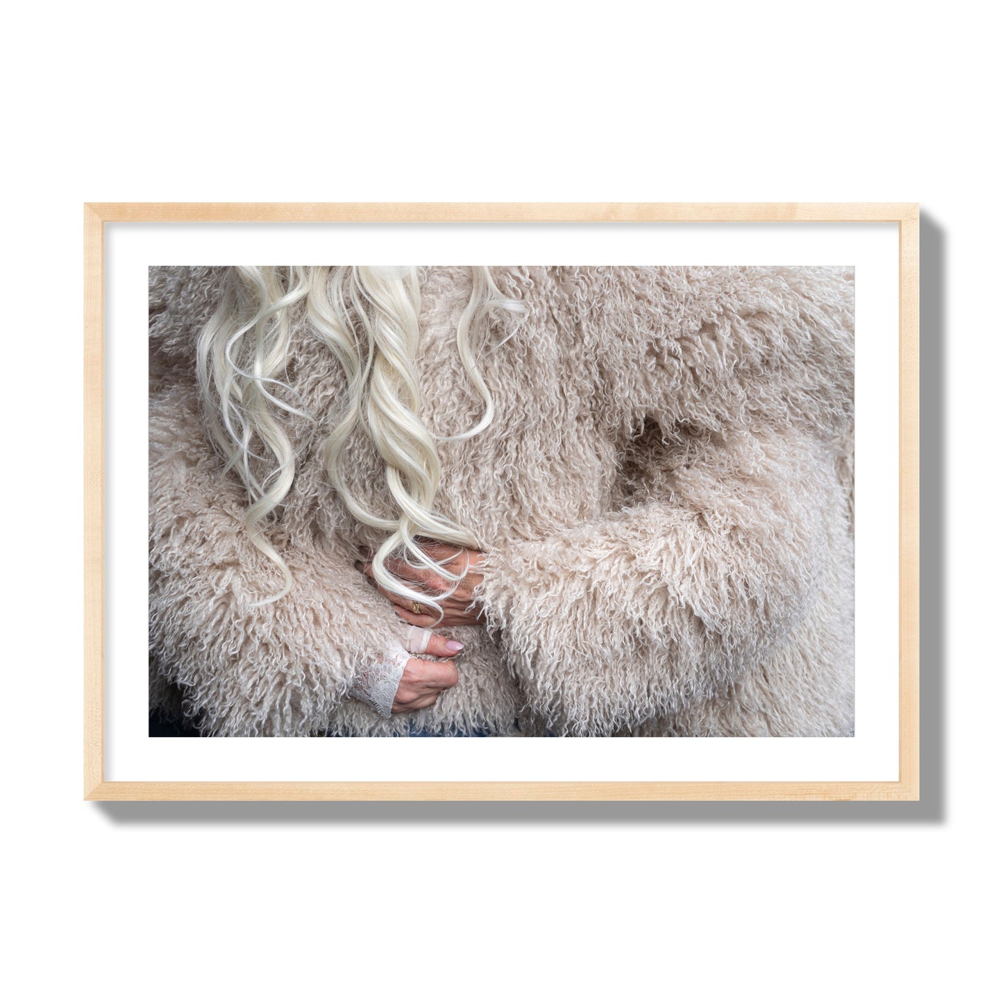 Fine art  street photograph of a woman wrapped in a huge furry coat. Archival pigment print, giant size, natural wood frame.