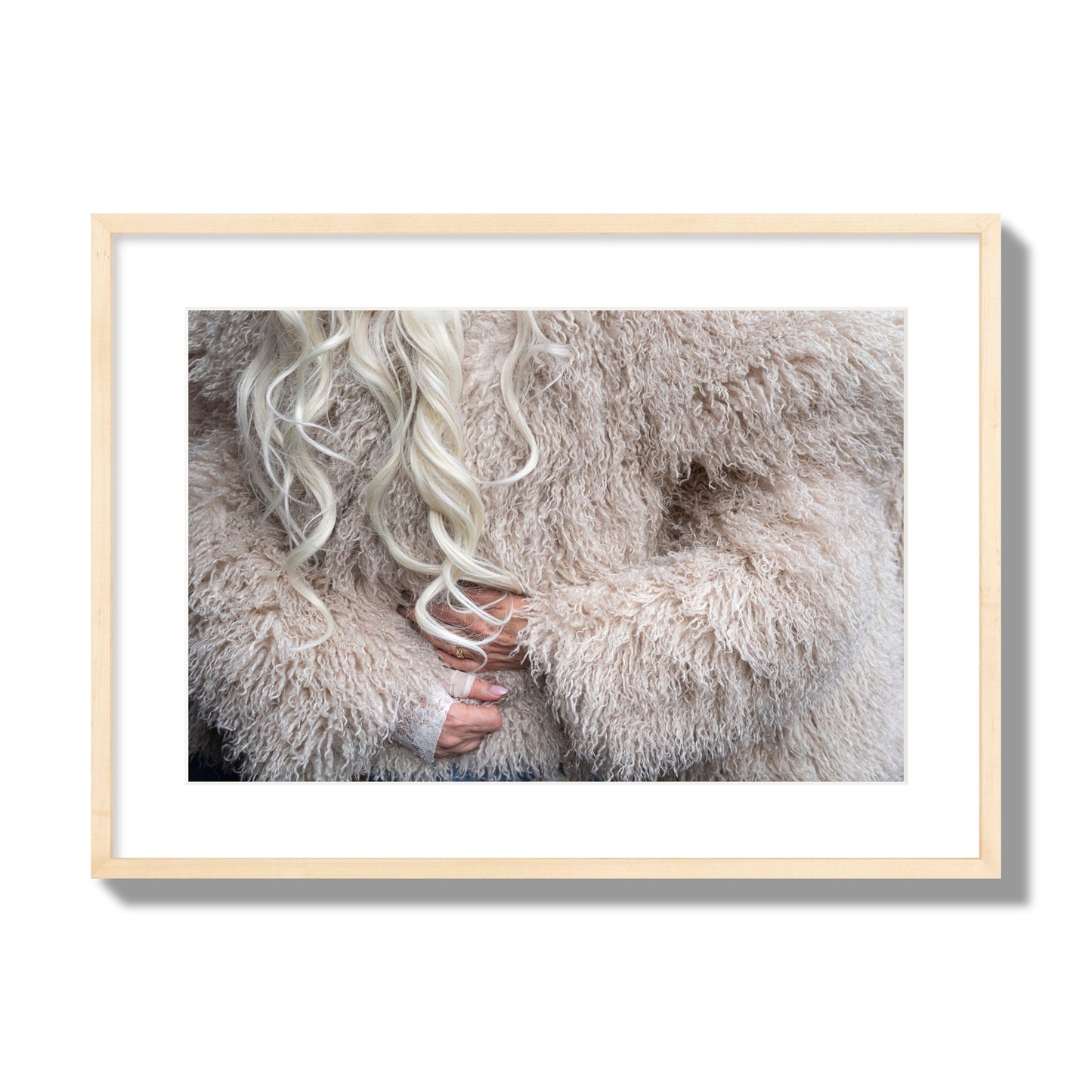 Fine art  street photograph of a woman wrapped in a huge furry coat. Archival pigment print, large size, natural wood frame.