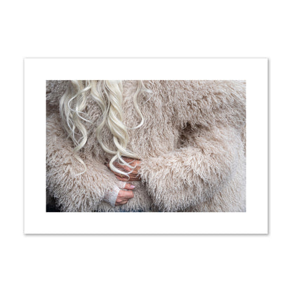 Fine art  street photograph of a woman wrapped in a huge furry coat. Archival pigment print, large size, print.