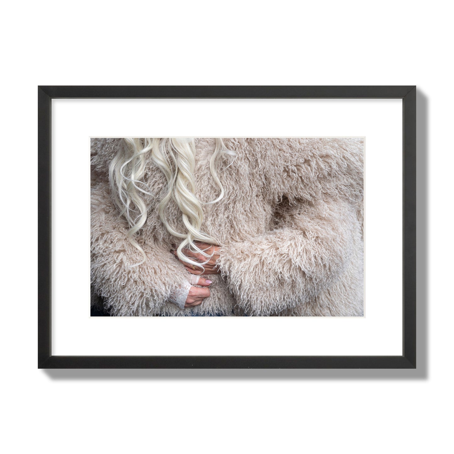 Fine art  street photograph of a woman wrapped in a huge furry coat. Archival pigment print, medium size, black frame.
