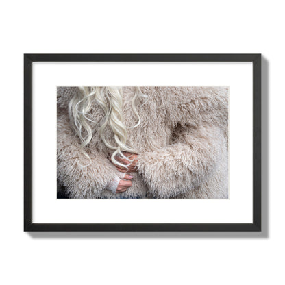 Fine art  street photograph of a woman wrapped in a huge furry coat. Archival pigment print, medium size, black frame.