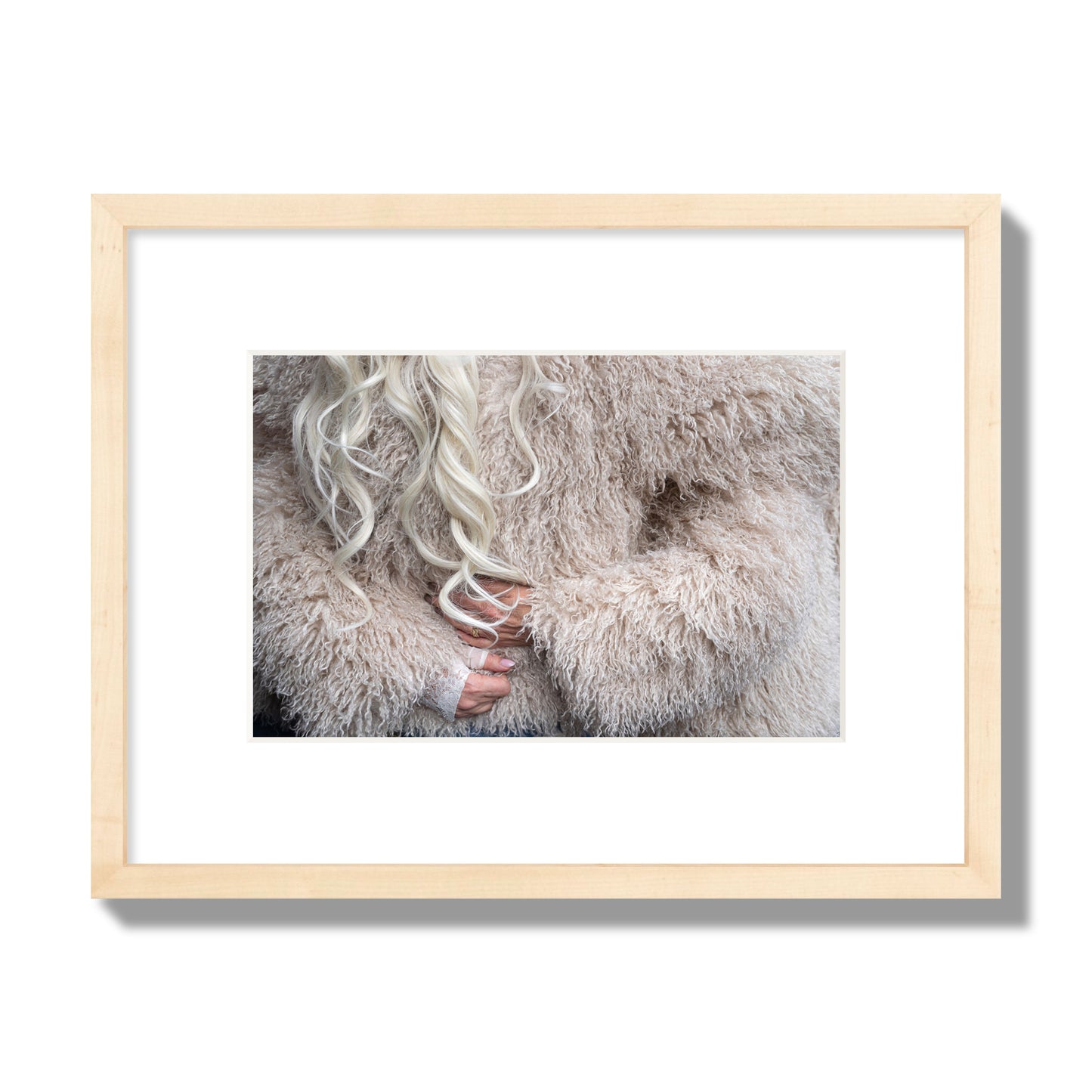 Fine art  street photograph of a woman wrapped in a huge furry coat. Archival pigment print, small size, natural wood frame.