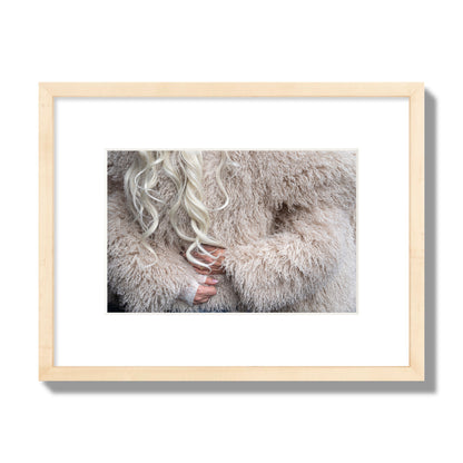 Fine art  street photograph of a woman wrapped in a huge furry coat. Archival pigment print, small size, natural wood frame.