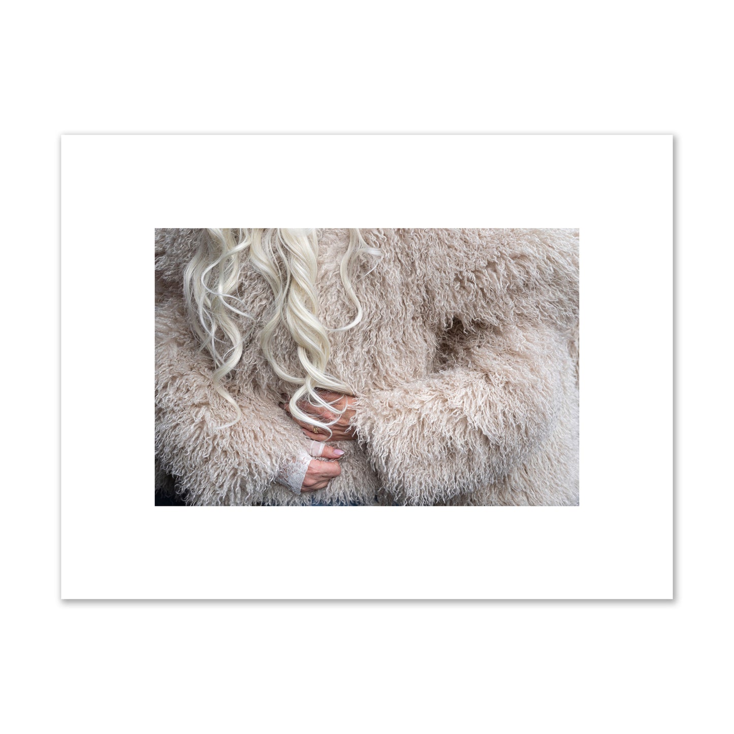 Fine art  street photograph of a woman wrapped in a huge furry coat. Archival pigment print, small size, print.