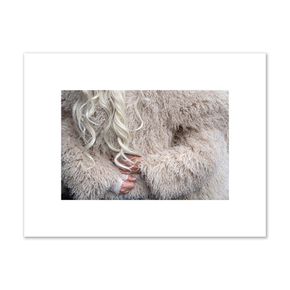 Fine art  street photograph of a woman wrapped in a huge furry coat. Archival pigment print, small size, print.