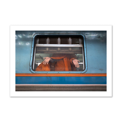 Fine art photograph of a Buddhist monk standing with open hands at a train car window. Archival pigment print, collector size, print.