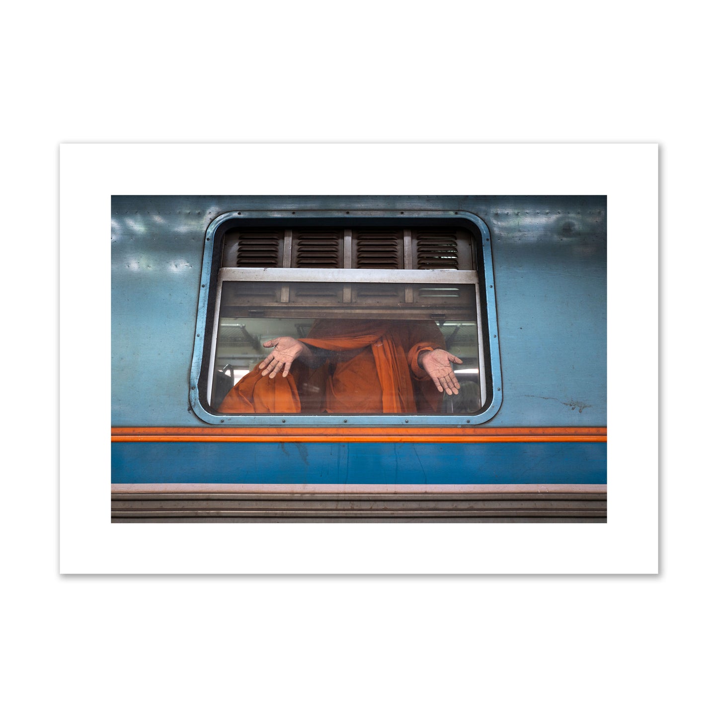 Fine art photograph of a Buddhist monk standing with open hands at a train car window. Archival pigment print, giant size, print.