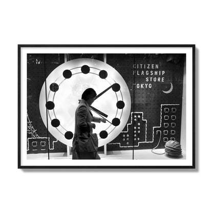 Fine art street photograph of a woman checking her watch as she walks past a giant clock on a busy Tokyo city street. Archival pigment print, collector size, black frame.