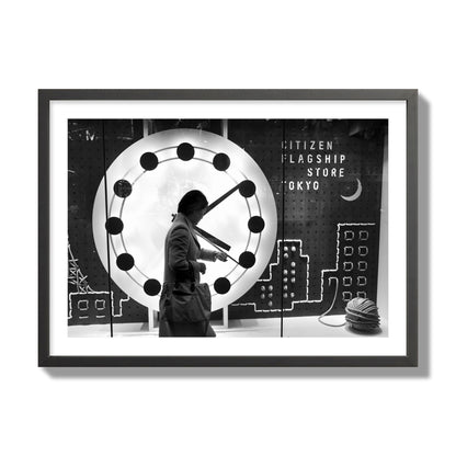Fine art street photograph of a woman checking her watch as she walks past a giant clock on a busy Tokyo city street. Archival pigment print, giant size, black frame.