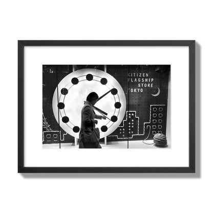 Fine art street photograph of a woman checking her watch as she walks past a giant clock on a busy Tokyo city street. Archival pigment print, medium size, black frame.