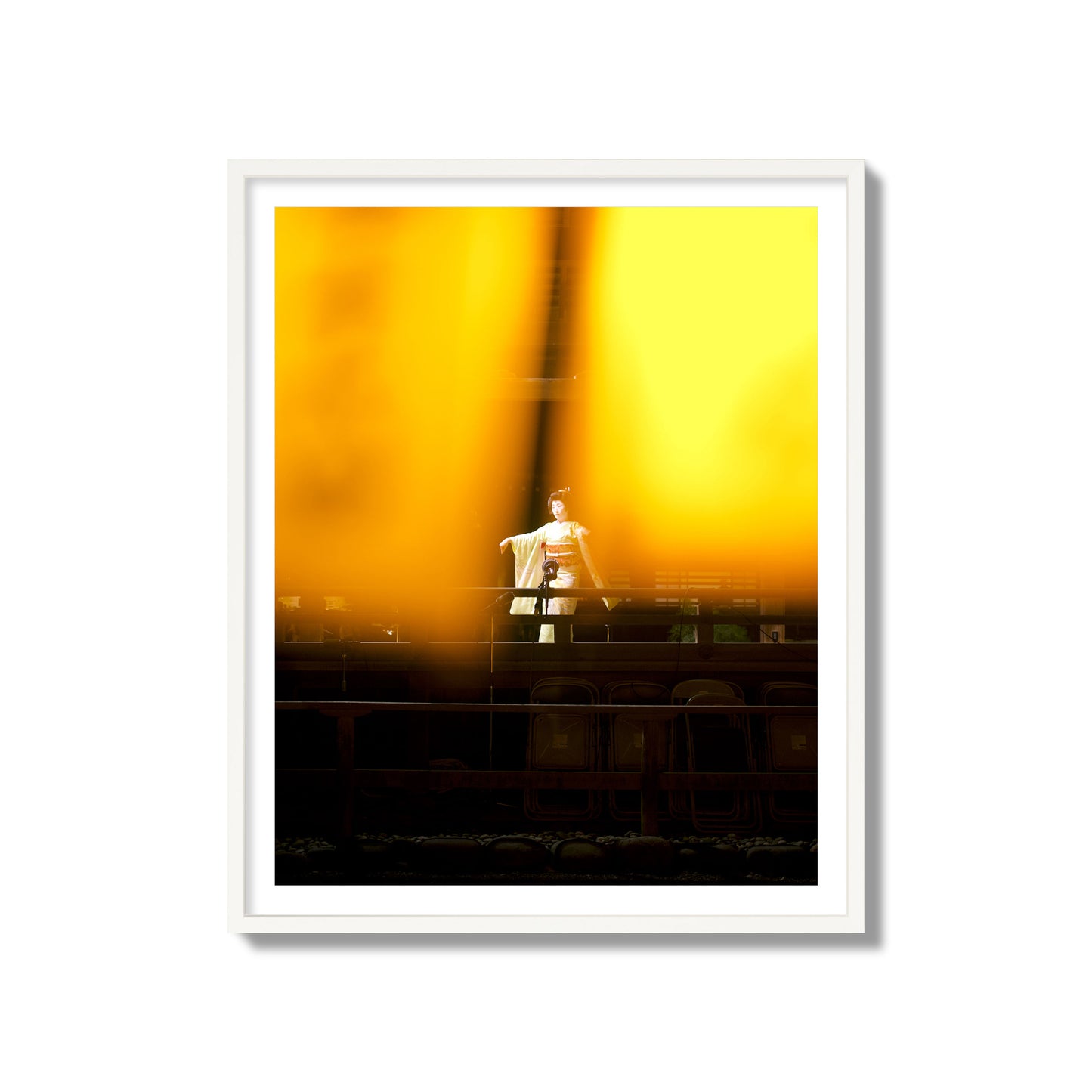 Fine art photograph of a geisha dancing, photographed through yellow lanterns, archival pigment print, collector size, white frame.