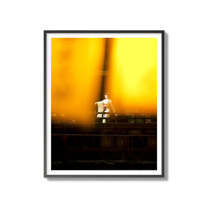 Fine art photograph of a geisha dancing, photographed through yellow lanterns, archival pigment print, gallery size, black frame.