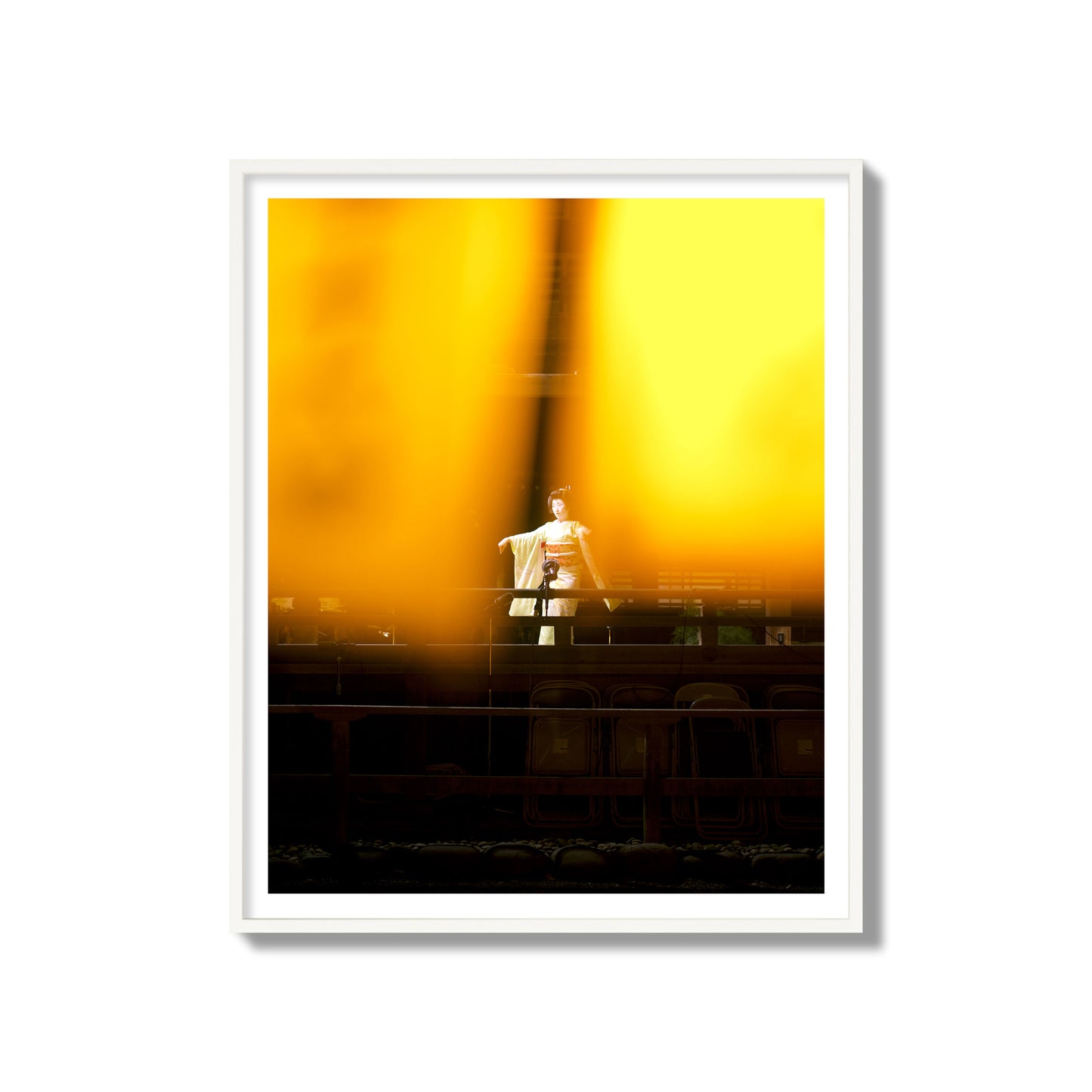Fine art photograph of a geisha dancing, photographed through yellow lanterns, archival pigment print, gallery size, white frame.