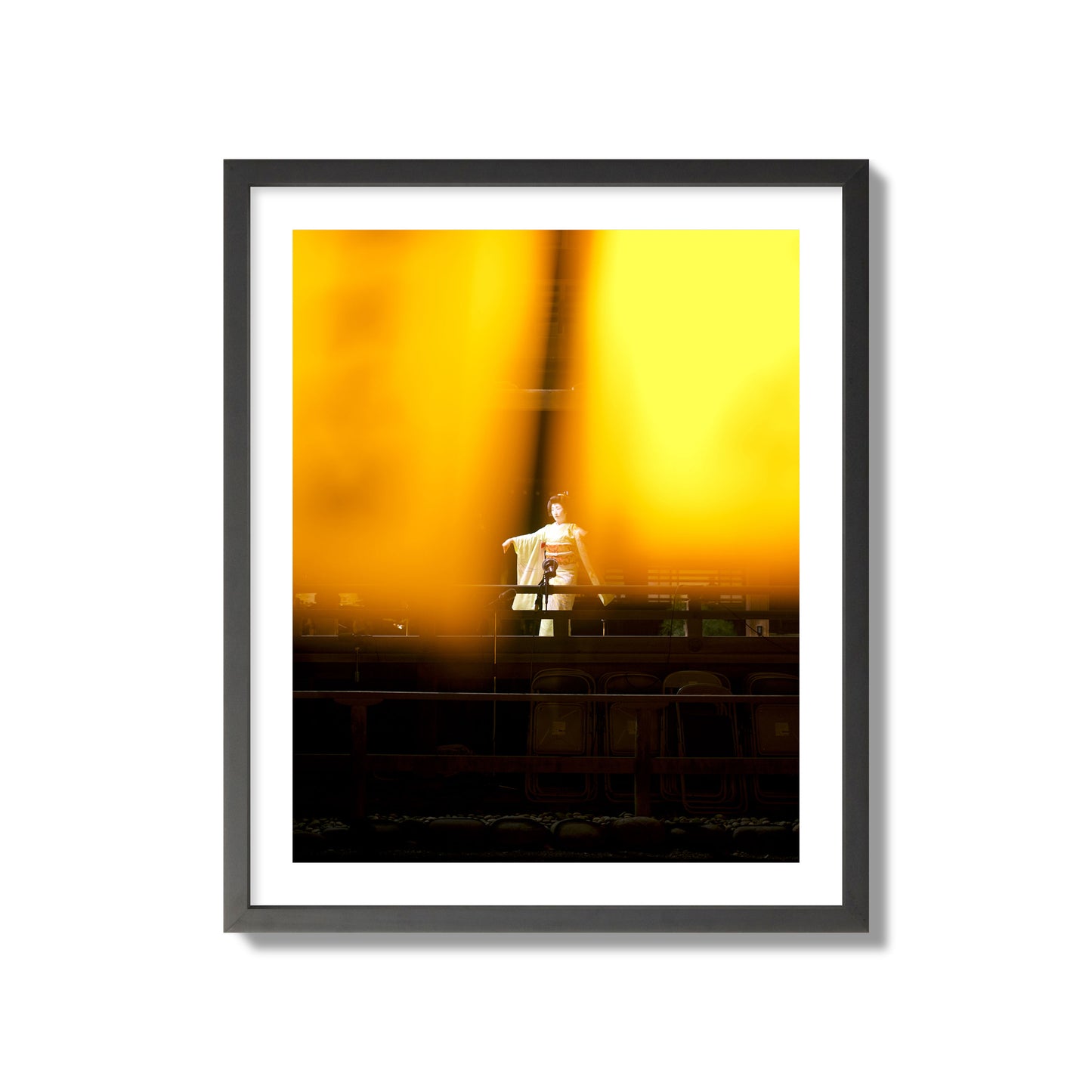 Fine art photograph of a geisha dancing, photographed through yellow lanterns, archival pigment print, giant size, black frame.