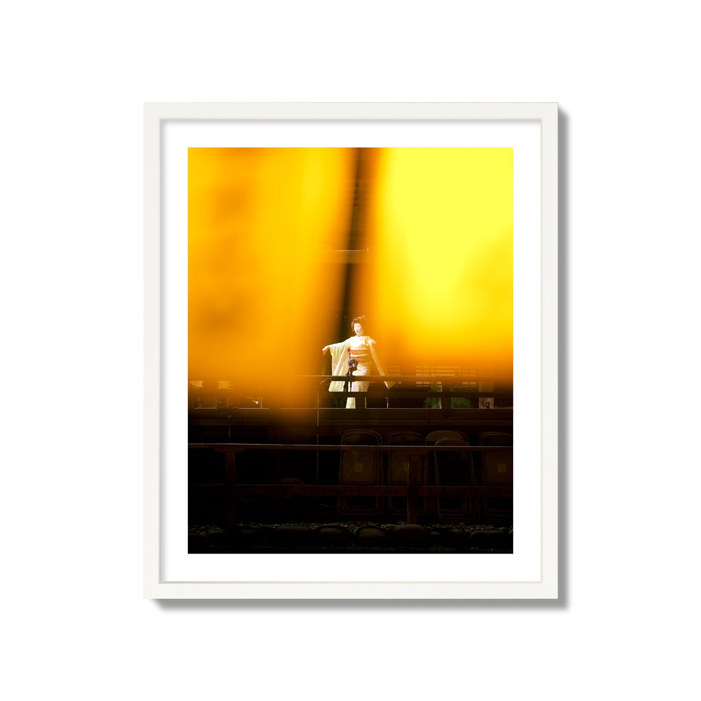 Fine art photograph of a geisha dancing, photographed through yellow lanterns, archival pigment print, giant size, white frame.