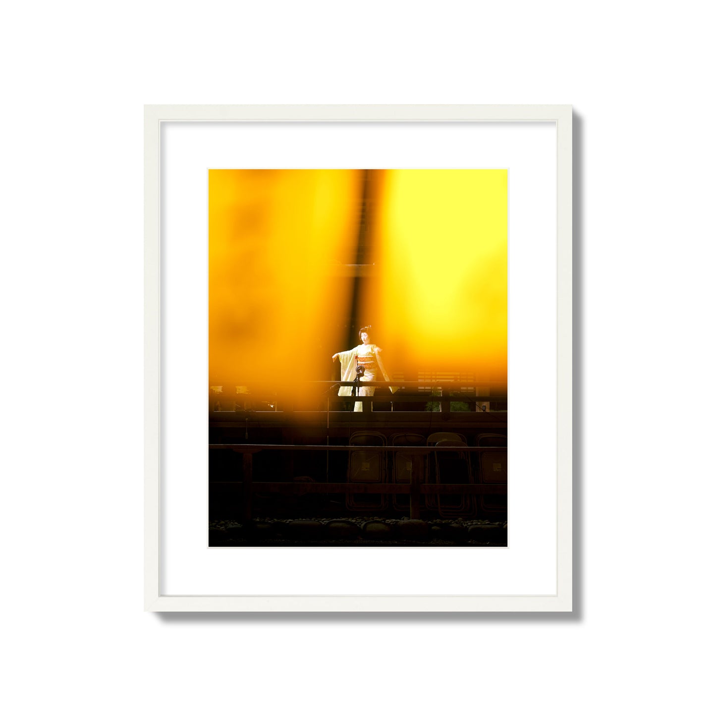 Fine art photograph of a geisha dancing, photographed through yellow lanterns, archival pigment print, large size, white frame.