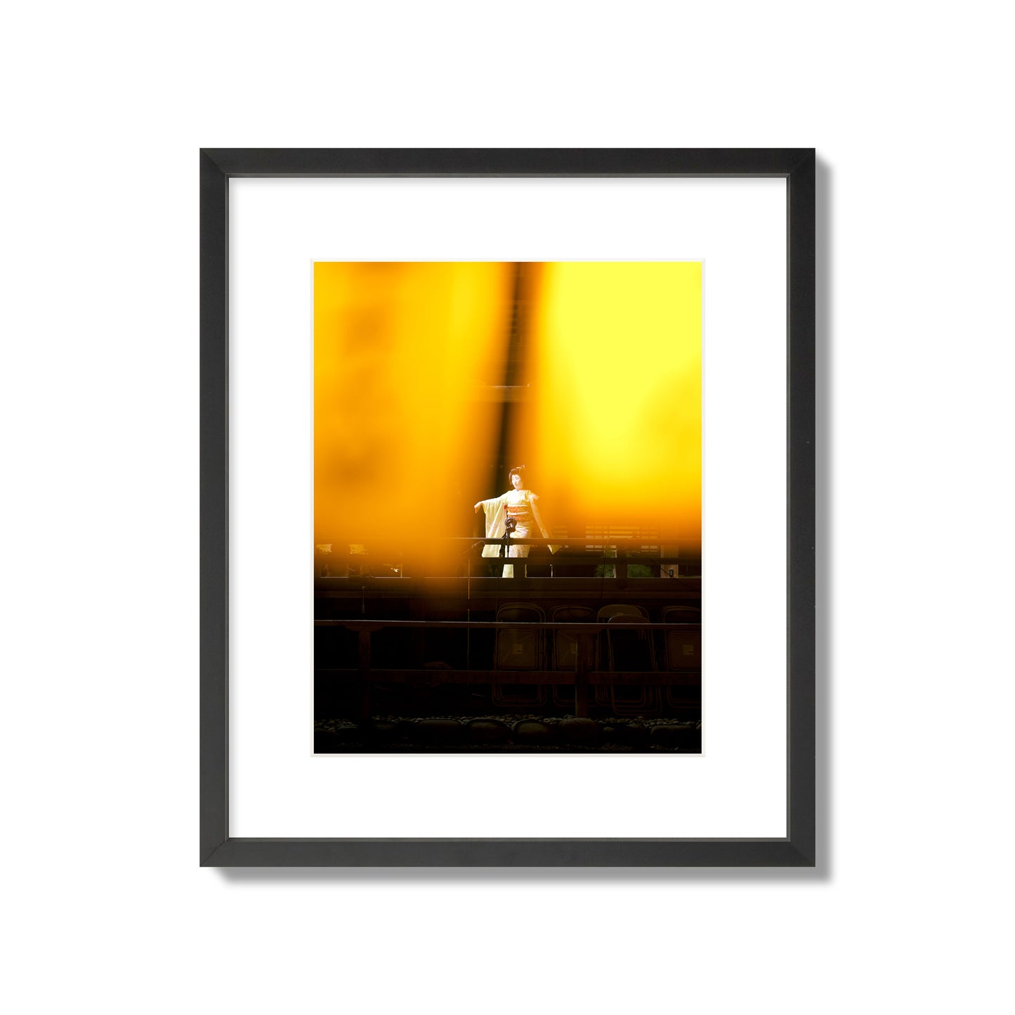 Fine art photograph of a geisha dancing, photographed through yellow lanterns, archival pigment print, medium size, black frame.