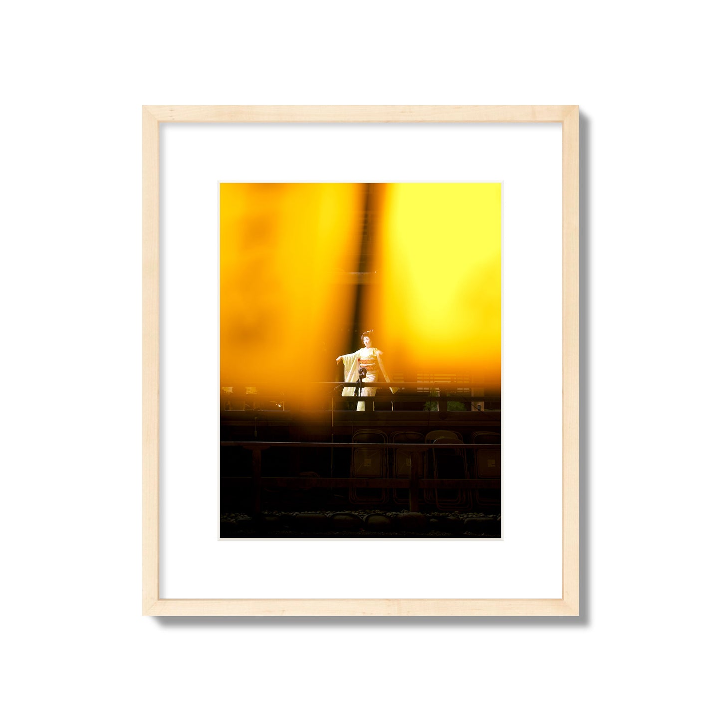 Fine art photograph of a geisha dancing, photographed through yellow lanterns, archival pigment print, medium size, natural wood frame.