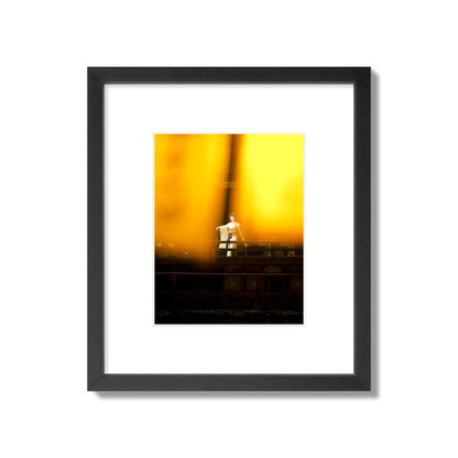 Fine art photograph of a geisha dancing, photographed through yellow lanterns, archival pigment print, small size, black frame.