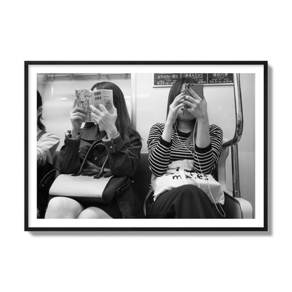Black and white fine art photograph of two women on the Tokyo Metro, archival pigment print, collector size, black frame
