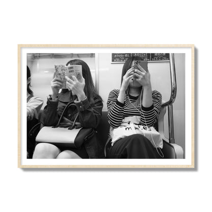 Black and white fine art photograph of two women on the Tokyo Metro, archival pigment print, collector size, natural wood frame