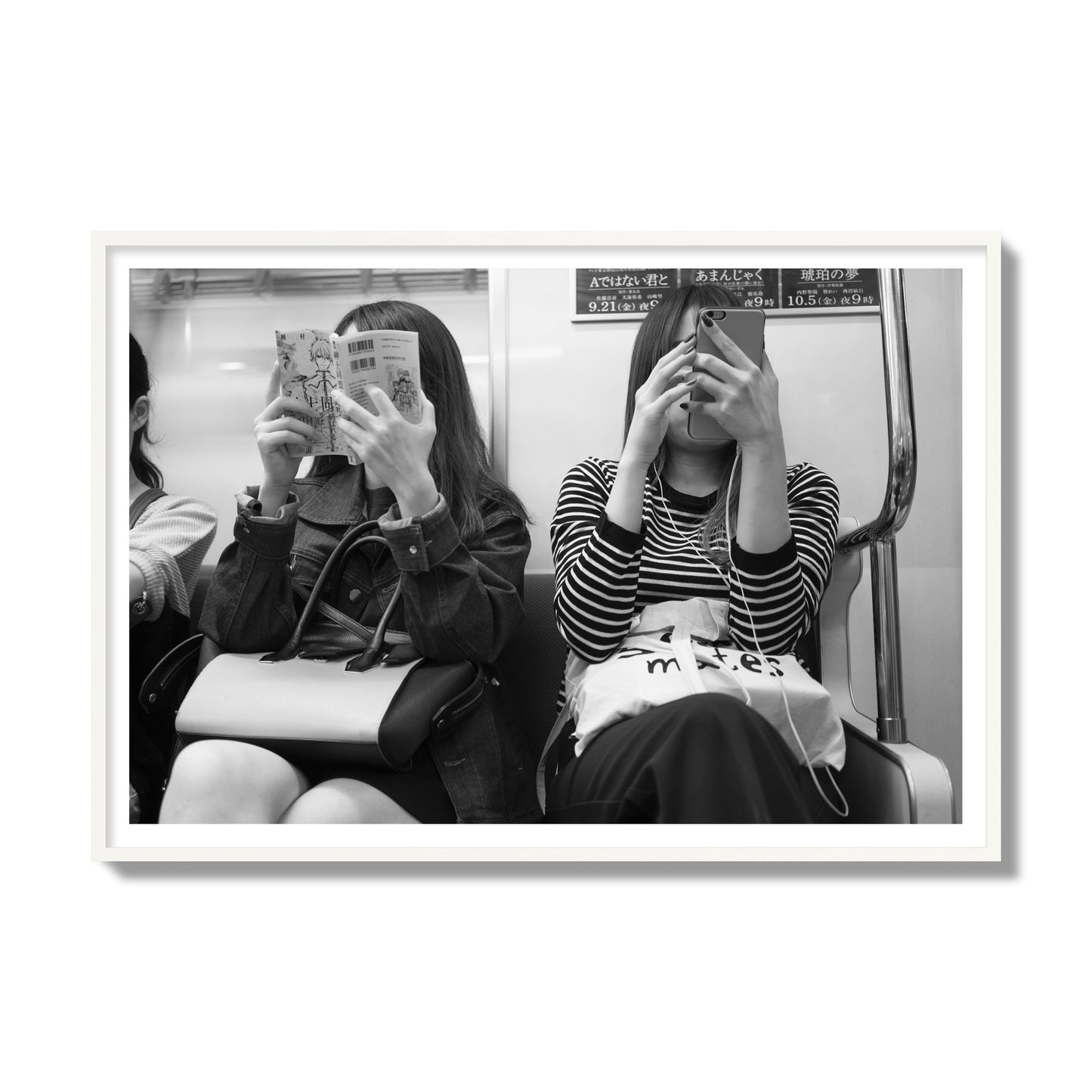 Black and white fine art photograph of two women on the Tokyo Metro, archival pigment print, gallery size, white frame