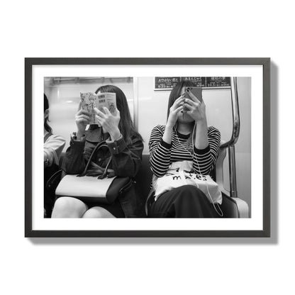 Black and white fine art photograph of two women on the Tokyo Metro, archival pigment print, giant size, black frame