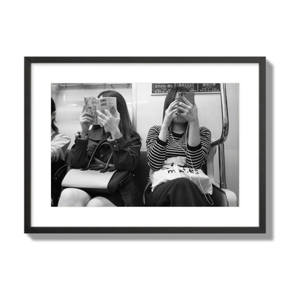 Black and white fine art photograph of two women on the Tokyo Metro, archival pigment print, large size, black frame