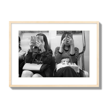 Black and white fine art photograph of two women on the Tokyo Metro, archival pigment print, large size, natural wood frame