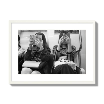 Black and white fine art photograph of two women on the Tokyo Metro, archival pigment print, large size, white frame