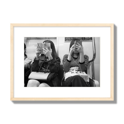 Black and white fine art photograph of two women on the Tokyo Metro, archival pigment print, medium size, natural wood frame