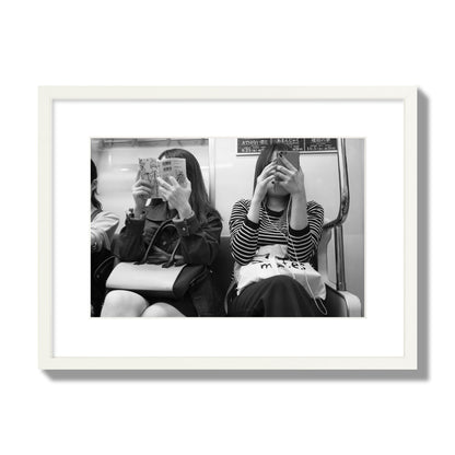 Black and white fine art photograph of two women on the Tokyo Metro, archival pigment print, medium size, white frame