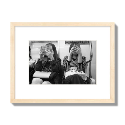 Black and white fine art photograph of two women on the Tokyo Metro, archival pigment print, small size, natural wood frame