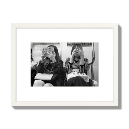 Black and white fine art photograph of two women on the Tokyo Metro, archival pigment print, small size, white frame