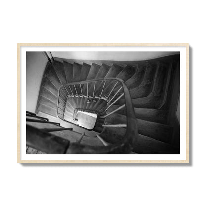 Fine art street photograph of a person walking down a staircase in Paris, France, archival pigment print, collector size, natural wood frame