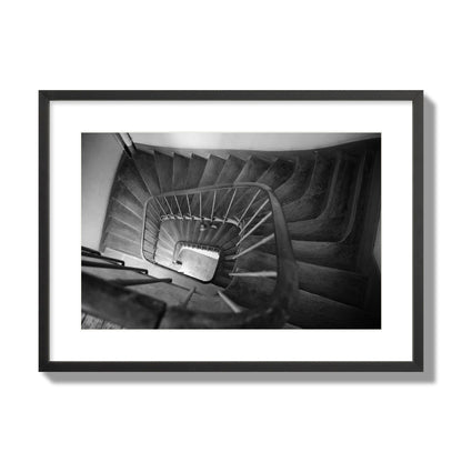 Fine art street photograph of a person walking down a staircase in Paris, France, archival pigment print, large size, black frame