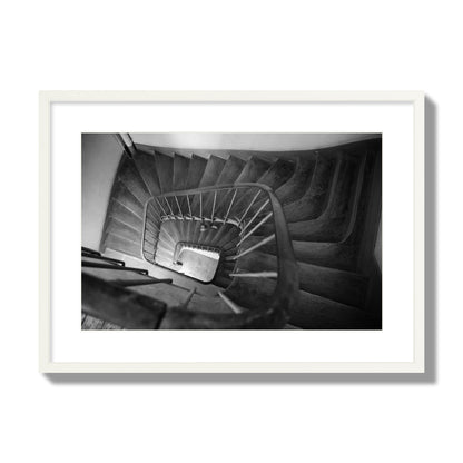 Fine art street photograph of a person walking down a staircase in Paris, France, archival pigment print, large size, white frame