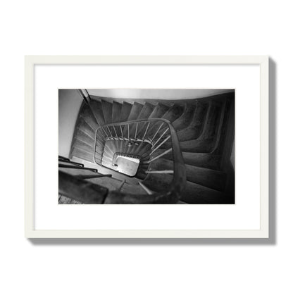 Fine art street photograph of a person walking down a staircase in Paris, France, archival pigment print, medium size, white frame