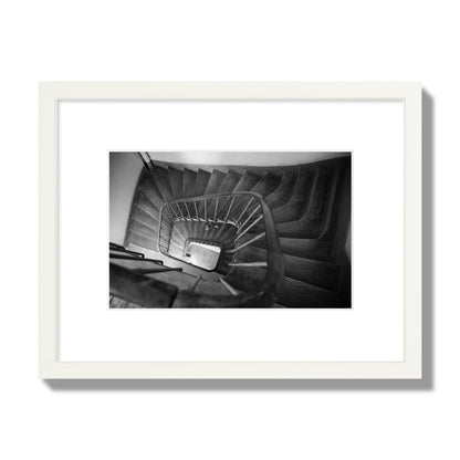 Fine art street photograph of a person walking down a staircase in Paris, France, archival pigment print, small size, white frame