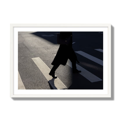 Fine art street photograph of a woman walking through a crosswalk in Soho New York, archival pigment print, giant size, white frame