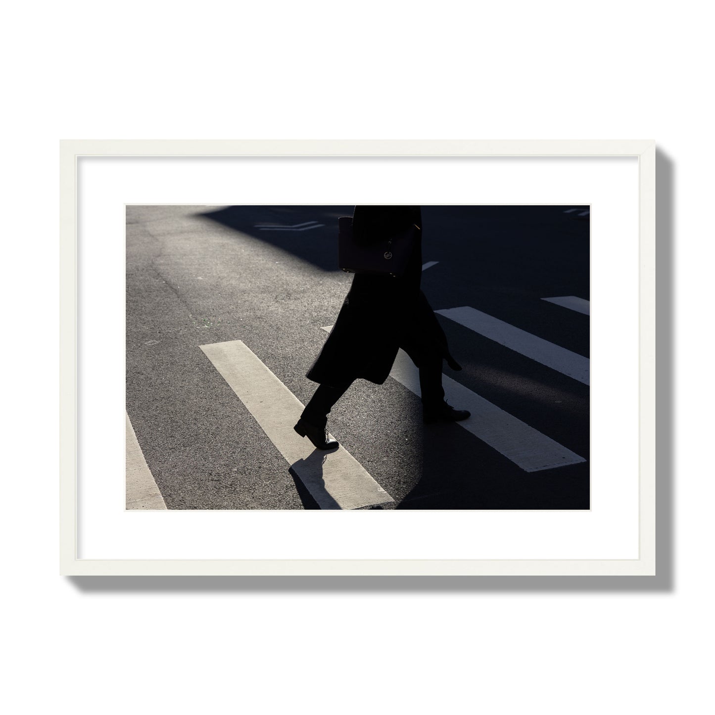 Fine art street photograph of a woman walking through a crosswalk in Soho New York, archival pigment print, large size, white frame